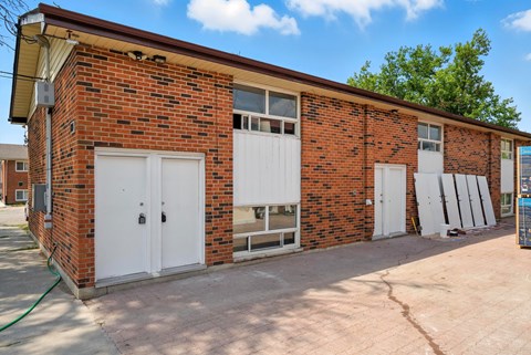 A red brick building with white garage doors.